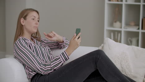 female-blogger-is-chatting-with-followers-by-smartphone-from-home-streaming-and-talking-to-camera-of-gadgets